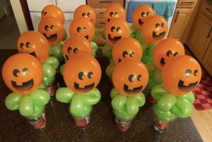 Several balloon pumpkin candy cups.