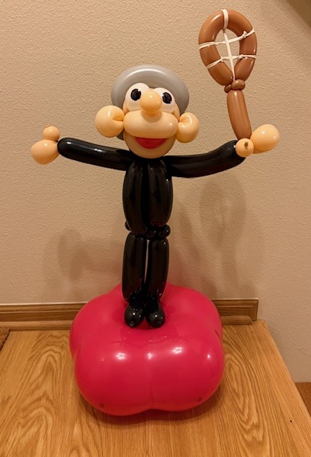 Pickleball balloon man holding a pickleball racket.